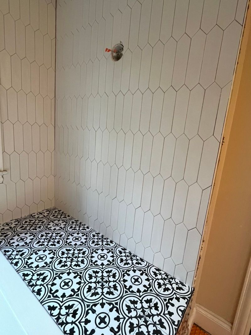 Picket tile shower with patterned floor
